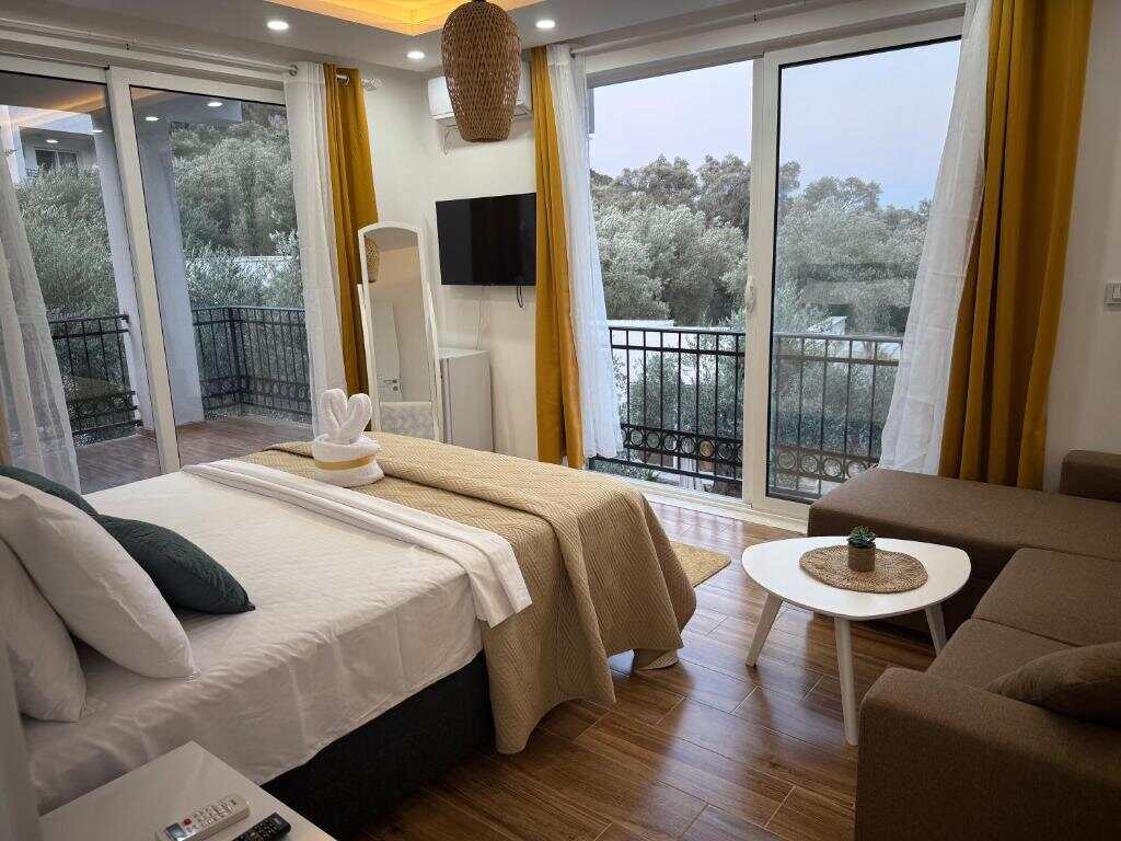 Apartment living area with balcony at Eman Resort